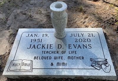 granite gravestone with teacher emblem